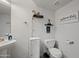 A minimalist bathroom featuring a pedestal sink, toilet, tiled floors, and neutral wall color at 985 N Granite Reef Rd # 127, Scottsdale, AZ 85257