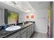 Bathroom with dual sinks, granite countertop and floral shower curtain at 985 N Granite Reef Rd # 127, Scottsdale, AZ 85257