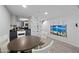 Contemporary dining room with a gray table, sleek chairs, and a partial view into the kitchen at 985 N Granite Reef Rd # 127, Scottsdale, AZ 85257