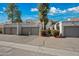 Charming townhome featuring multiple units, garages, and beautiful desert landscaping on a sunny day at 985 N Granite Reef Rd # 127, Scottsdale, AZ 85257