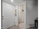 A hallway leading to a bathroom, featuring neutral tones, tiled floors, and a clean, minimalist aesthetic at 985 N Granite Reef Rd # 127, Scottsdale, AZ 85257