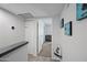 Upper hallway with grey floors leads to bedroom; features closet and modern art; bright and inviting at 985 N Granite Reef Rd # 127, Scottsdale, AZ 85257