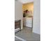 Convenient laundry room area features a washer and dryer, plus upper shelf for storage at 985 N Granite Reef Rd # 127, Scottsdale, AZ 85257