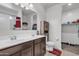 Bright bathroom displays a double sink vanity, large mirror, and a walk-in closet for convenient storage at 10320 E Lupine Ln, Florence, AZ 85132