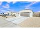 Single-story home boasting low-maintenance desert landscaping and a wide driveway leading to a two-car garage at 10320 E Lupine Ln, Florence, AZ 85132