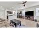 Open concept living area with a seamless flow into the kitchen, tiled floors, and a cozy fireplace at 10320 E Lupine Ln, Florence, AZ 85132