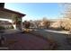 Spacious backyard featuring a covered patio area with tile, gravel landscaping and mature trees at 10322 W Reade Ave, Glendale, AZ 85307