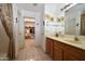 Well-lit bathroom with a vanity and a walk-in closet at 10322 W Reade Ave, Glendale, AZ 85307