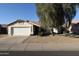 Single story home featuring desert landscaping, tile roof and a two car garage at 10322 W Reade Ave, Glendale, AZ 85307