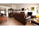 Inviting living room with tile flooring, a leather sofa, and an open floor plan at 10322 W Reade Ave, Glendale, AZ 85307