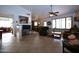 Spacious living room with tile flooring, a ceiling fan, and a view into the eat-in kitchen at 10322 W Reade Ave, Glendale, AZ 85307