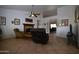 Relaxing living room with tile flooring, a brick fireplace, and an open floor plan at 10322 W Reade Ave, Glendale, AZ 85307