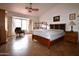 Bright main bedroom with tile flooring, a ceiling fan, and a large window with curtains at 10322 W Reade Ave, Glendale, AZ 85307