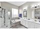 Elegant bathroom with a glass-enclosed shower, soaking tub, double sink vanity, and modern fixtures at 108 N Pioneer St, Gilbert, AZ 85233