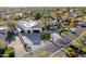 An aerial view of a modern home with a three car garage and manicured lawn in a lush neighborhood at 10800 E Cactus Rd # 38, Scottsdale, AZ 85259