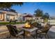 Backyard patio features a fire pit, outdoor seating, pool, and lush landscaping at 10800 E Cactus Rd # 38, Scottsdale, AZ 85259