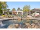 The backyard is surrounded by lush landscaping and features a pool with water features and a covered patio at 10800 E Cactus Rd # 38, Scottsdale, AZ 85259