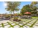 Beautiful backyard featuring outdoor seating, green turf squares, and a rock waterfall pool feature at 10800 E Cactus Rd # 38, Scottsdale, AZ 85259