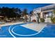 A view of the outdoor basketball court with a seating area and water feature in the backyard at twilight at 10800 E Cactus Rd # 38, Scottsdale, AZ 85259