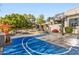 A view of the outdoor basketball court with a seating area and water feature in the backyard at 10800 E Cactus Rd # 38, Scottsdale, AZ 85259