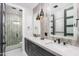 Dual vanity bathroom featuring pendant lights, mirrors, and sleek fixtures at 10800 E Cactus Rd # 38, Scottsdale, AZ 85259