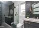 Contemporary bathroom with a glass-enclosed shower, geometric tile accent wall, and stylish vanity at 10800 E Cactus Rd # 38, Scottsdale, AZ 85259