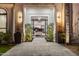 A grand entrance featuring manicured landscaping and a glimpse into the home's modern interior at 10800 E Cactus Rd # 38, Scottsdale, AZ 85259