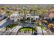 Beautiful white home featuring a paved driveway, palm trees, meticulous landscaping and a three-car garage at 10800 E Cactus Rd # 38, Scottsdale, AZ 85259
