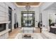 Elegant living room with fireplace, chandelier, and views of the entrance through glass doors at 10800 E Cactus Rd # 38, Scottsdale, AZ 85259