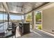 This outdoor living space features a kitchen with a bar, grill, and lounge area with patterned turf at 10800 E Cactus Rd # 38, Scottsdale, AZ 85259