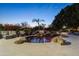 Stunning pool with rock waterfall feature, lounge chairs, and ambient lighting creates a backyard oasis at 10800 E Cactus Rd # 38, Scottsdale, AZ 85259