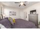 Cozy primary bedroom showcasing a chest of drawers with TV, ceiling fan and decorative wall photos at 10960 E Monte Ave # 242, Mesa, AZ 85209