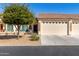 Charming home featuring a xeriscaped front yard, covered porch with comfortable seating, and attached two-car garage at 10960 E Monte Ave # 242, Mesa, AZ 85209