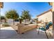 Relaxing front porch with comfortable seating area, colorful flower pots, and desert landscaping at 10960 E Monte Ave # 242, Mesa, AZ 85209