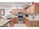 Modern kitchen featuring granite countertops, stainless steel appliances, tile backsplash and wooden cabinetry at 10960 E Monte Ave # 242, Mesa, AZ 85209