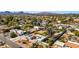 Wide aerial shot capturing a desert neighborhood with mountain views at 11616 N Miller Rd, Scottsdale, AZ 85260