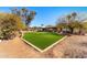 Backyard features artificial turf area and mature trees. Covered patio area for entertaining at 11616 N Miller Rd, Scottsdale, AZ 85260