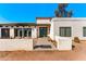 Charming desert home with stucco exterior, red tile roof, and green trim on windows and doors at 11616 N Miller Rd, Scottsdale, AZ 85260