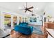 Bright living room with hardwood floors, large windows, ceiling fans and contemporary furnishings at 11616 N Miller Rd, Scottsdale, AZ 85260