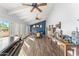 Large living room with exposed beams, ceiling fans, hardwood floors, and elegant decorations at 11616 N Miller Rd, Scottsdale, AZ 85260