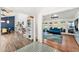 Bright living room with hardwood floors, blue sofa and area rug, and wall of sliding glass doors at 11616 N Miller Rd, Scottsdale, AZ 85260