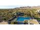 High angle view of community pool, green spaces, and mountain views in the background at 11627 E Bella Vista Dr, Scottsdale, AZ 85259