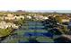 An aerial view showing well-maintained tennis courts nestled in a residential neighborhood at 11627 E Bella Vista Dr, Scottsdale, AZ 85259