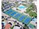 Aerial view of community tennis courts and pool surrounded by palm trees at 11627 E Bella Vista Dr, Scottsdale, AZ 85259