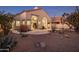 Stunning home's backyard featuring desert landscaping and a rock water feature at 11627 E Bella Vista Dr, Scottsdale, AZ 85259