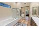 Luxurious bathroom featuring a separate tub and shower, mirrored closet doors, and neutral tones, offering a spa-like experience at 11627 E Bella Vista Dr, Scottsdale, AZ 85259