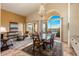 Inviting dining area with a glass table, chandelier, and scenic outdoor views, perfect for entertaining guests at 11627 E Bella Vista Dr, Scottsdale, AZ 85259