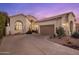 Charming stucco home featuring a two-car garage and desert landscaping for a clean, modern look at 11627 E Bella Vista Dr, Scottsdale, AZ 85259