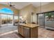 Modern kitchen island with granite countertops, stainless steel appliances, and ample natural light at 11627 E Bella Vista Dr, Scottsdale, AZ 85259