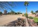 View of backyard and desert landscaping beyond the fence in this well-maintained home at 12439 W Monte Vista Rd, Avondale, AZ 85392